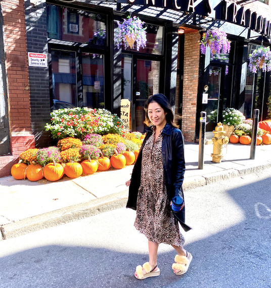 sandals designer wearing fur platform wedge with orange pumpkins at halloween market in New York City