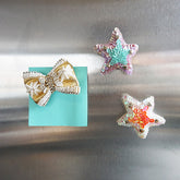 Blue and pink sequin star, gold ribbon
